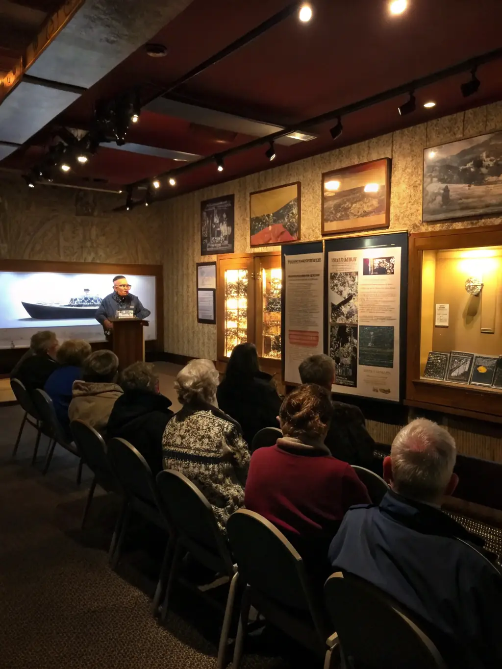A photograph of participants attending a lecture on maritime history at Fort Louvois, with a focus on the fort's role in coastal defense.